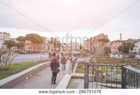 Rome, Italy - February 23, 2019: Rome Tourist Sidewalk Coliseum Street People Walking