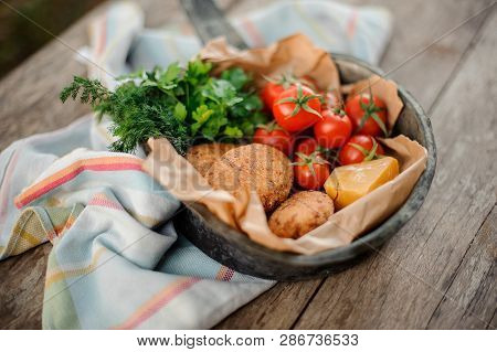 Traditional Georgian Dish Mchadi In The Pot On A Light Striped Tablecloth