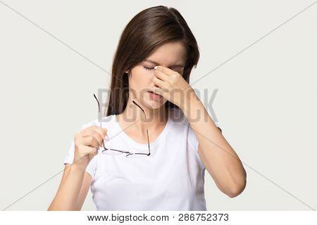 Tired Girl Taking Off Glasses Feel Eyestrain Isolated On Background
