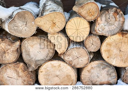 Abstraction Wooden Chocks For Home Heating Stacked On Each Other Under A Canopy In Winter