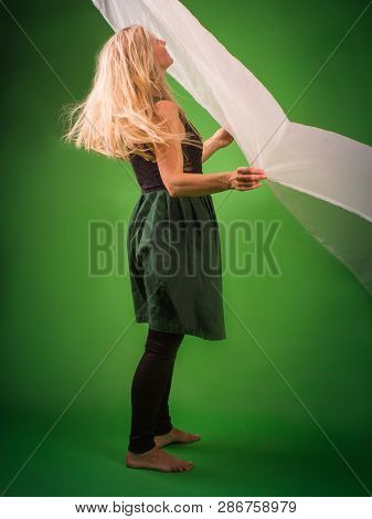 Blonde With Rumpled Hair Looking Up At Withholds White Silk.