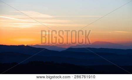 Silhouette Sunset Orange And Blue Mountain And Foggy Valley