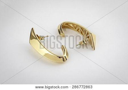 Female, Glossy Gold Earrings Isolated On White Background.