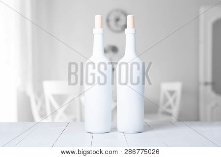 Red Wine Bottle On A White Wooden Background