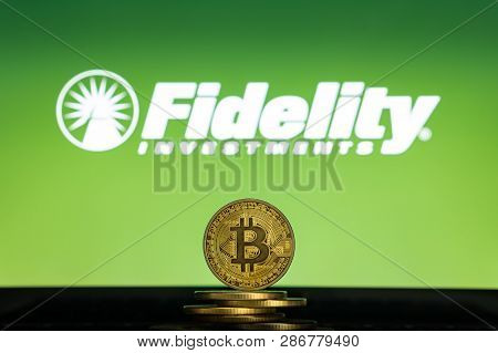 Bitcoin On A Stack Of Coins With Fidelity Logo On A Laptop Screen. Cryptocurrency And Blockchain Ado