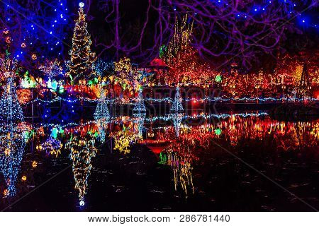 Vancouver, Canada - December 15, 2018 Blue Red Christmas Trees Lights Reflection Lake Van Dusen Gard