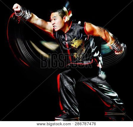 whushu chinese boxing kung fu Hung Gar fighter isolated man isolated on black background with speed light painting effect motion blur