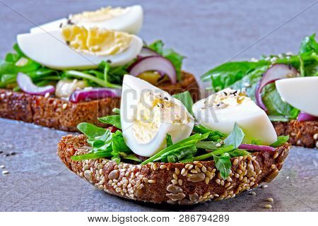Healthy Fitness Toasts With Arugula And Egg. Useful Snack Lunch. Useful Vegetarian Toast. Open Sandw