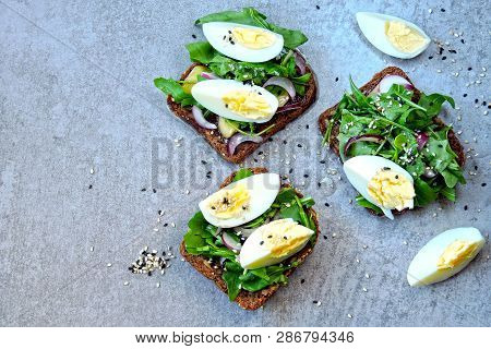 Healthy Fitness Toasts With Arugula And Egg. Useful Snack Lunch. Useful Vegetarian Toast. Open Sandw