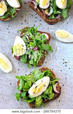 Healthy Fitness Toasts With Arugula And Egg. Useful Snack Lunch. Useful Vegetarian Toast. Open Sandw