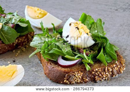 Healthy Fitness Toasts With Arugula And Egg. Useful Snack Lunch. Useful Vegetarian Toast. Open Sandw