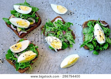 Healthy Fitness Toasts With Arugula And Egg. Useful Snack Lunch. Useful Vegetarian Toast. Open Sandw