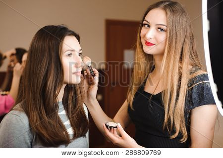 Make Up Artist Doing Professional Make Up Of Young Woman. Beauty Shcool.