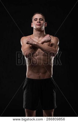 Wet Young Man Crossed His Fists, Standing In A Belligerent Pose