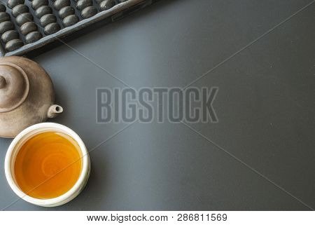 Abacus And Chinese Tea Set Placed On A Black Table During Breaks To Drink Tea