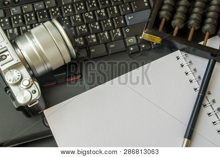 Camera, Laptop And Notebook Are Put Together On The Table To Prepare For Work.