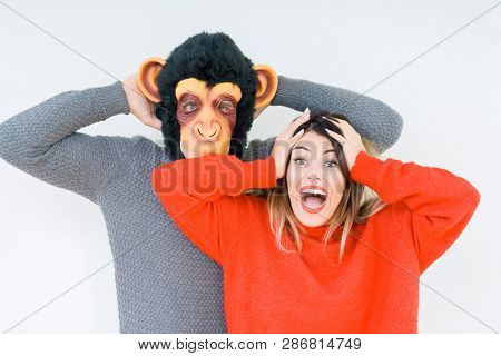Funny young couple, boyfriend wearing monkey mask, crazy and idiot relationship in love