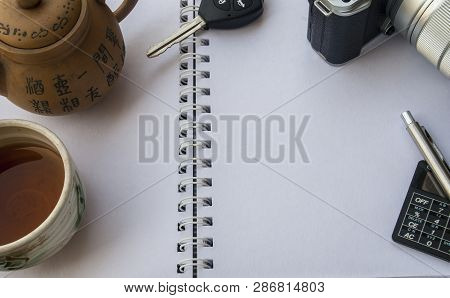 Notebooks That Are Overlaid With Chinese Tea Sets, Car Keys, Pen Cameras And Calculators During Brea