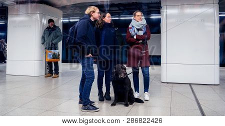 Hamburg, Germany - Mar 22, 2018: Three Friends With A Dog Waiting In Metro For Train