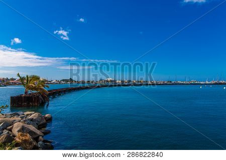 The Long Sweeping Seawall Protecting The Harbor In Marigot, Saint Martin
