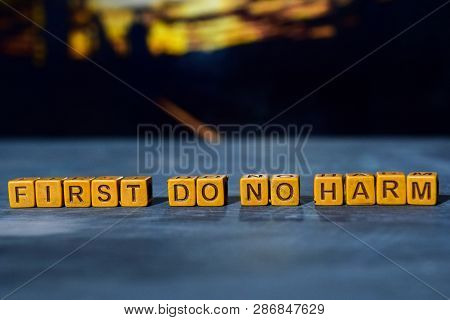 First Do No Harm On Wooden Blocks. Cross Processed Image With Bokeh Background