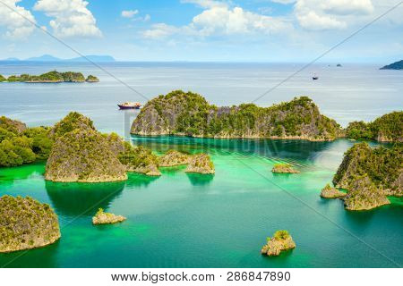 Picturesque place - paradise lagoon with islands and turquoise calm water, Raja Ampat, Papua, Indonesia. 