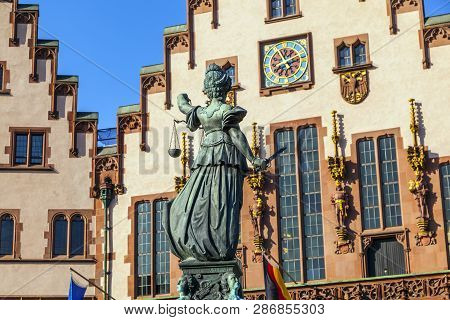 Lady Justice Standing At The Fountain Under Blue Sky In Frankfurt As A Symbol Of Justice