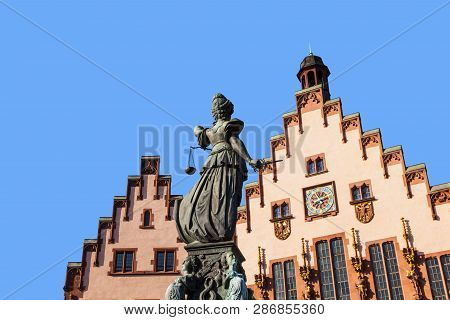 Lady Justice Standing At The Fountain Under Blue Sky In Frankfurt As A Symbol Of Justice