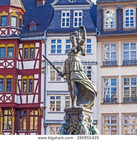 Lady Justice Standing At The Fountain Under Blue Sky In Frankfurt As A Symbol Of Justice