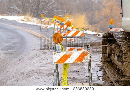 Traffic Barricades And Excavator On The Road