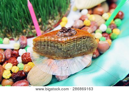 Navruz Nowruz Holiday, The Spring New Year Holiday. Baklava Is In The Background Xoncha . Isolated A