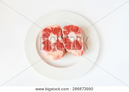 Fresh Cutting Raw Oxtail Or Beef With Bone, Tail Path Of Cow On White Plate And White Background. Ox