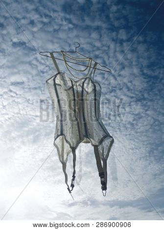 Romantic Corset With Beads And Laces On Blue, But Beutiful Cloudy Sky