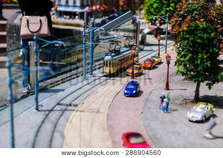 Netherlands. Den Haag. Miniature Park Madurodam.july 2016. Old Tram In The Street. Mini Human Figure