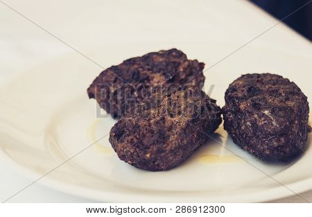 Fried Minced Meat Of Horsemeat, Traditional Sicilian Lunch On A White Plate In A Restaurant Of Catan