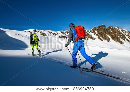 Two Alpinist Skiers During A Ski Mountaineering Trip