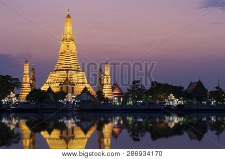 Wat Arun Landmark Of Bangkok, Thailand At Dusk With Water Reflection At Choa Phraya River Twilight.