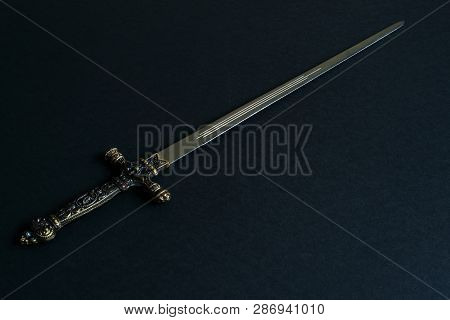 European Dagger-stylet (replica) With Bronze Handle Decorated With Medieval Original Pattern On Blac