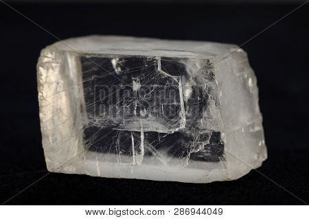 Raw Iceland Spar From Krasnoyarsk Region, Russia On Black Cement Background.