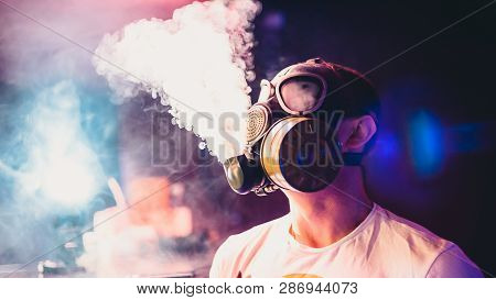 Man Lets Clouds Of Hookah Smoke In A Gas Mask