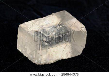 Raw Iceland Spar From Krasnoyarsk Region, Russia On Black Cement Background.