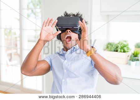 African amaerican man having fun playing with virtual reality glasses