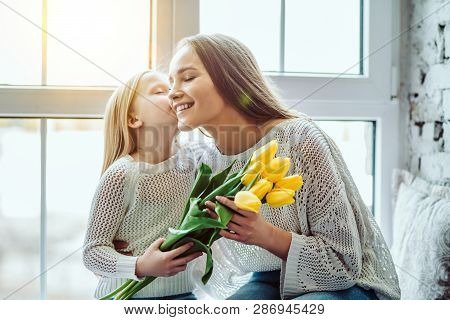 Нappy Mothers Day!child Congratulates Mother And Gives A Bouquet Of Flowers To Tulips.