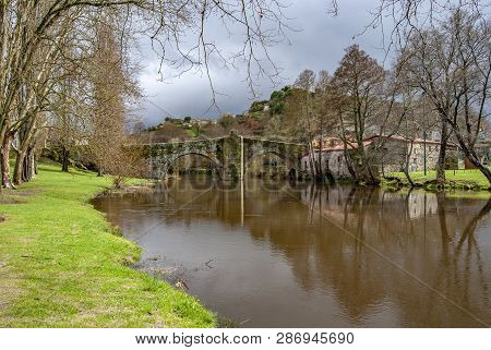 Old Bridge Above The City River, Arnoia, In The Medieval Town Of Allariz, Spain