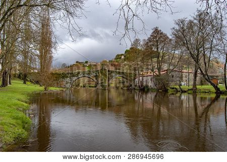 Old Bridge Above The City River, Arnoia, In The Medieval Town Of Allariz, Spain