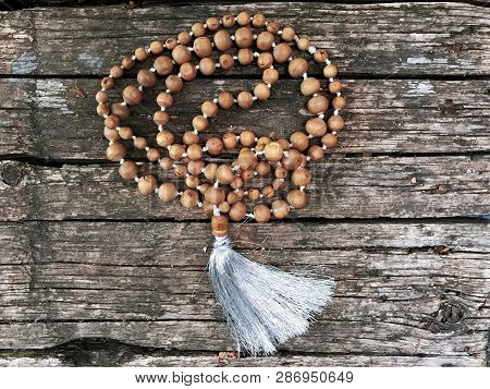 Rosary Beads On The Wooden Background. Rudraksha Mala For Mantras. 108 Beads.