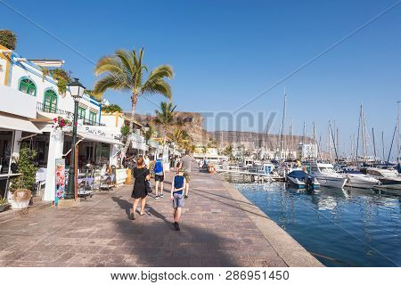 Puerto De Mogan, Spain - February 24, 2019 : Tourist Visiting Puerto De Mogan Marina, Small Fishing 