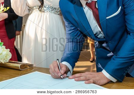 The Groom Signing Registration Of Marriage Certificate In Serbian Civil Registry Office. Close Up.