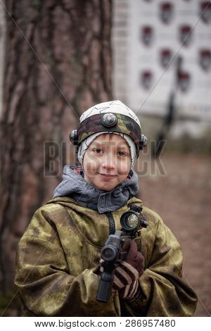 Boy With A Gun Playing Lasertag On Nature In Spring Park.