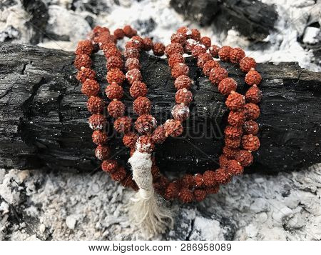 Rosary Prayer Beads On The Ash Cinder Background. Rudraksha. Mala. Mantra. 108 Beads.